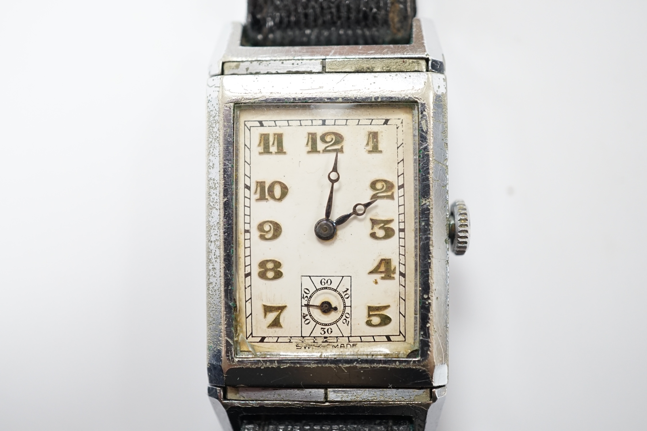 A gentleman's mid 20th century steel 'reverso' manual wind rectangular dial wrist watch, with Arabic dial and subsidiary seconds, the back with engraved initials and enamel.